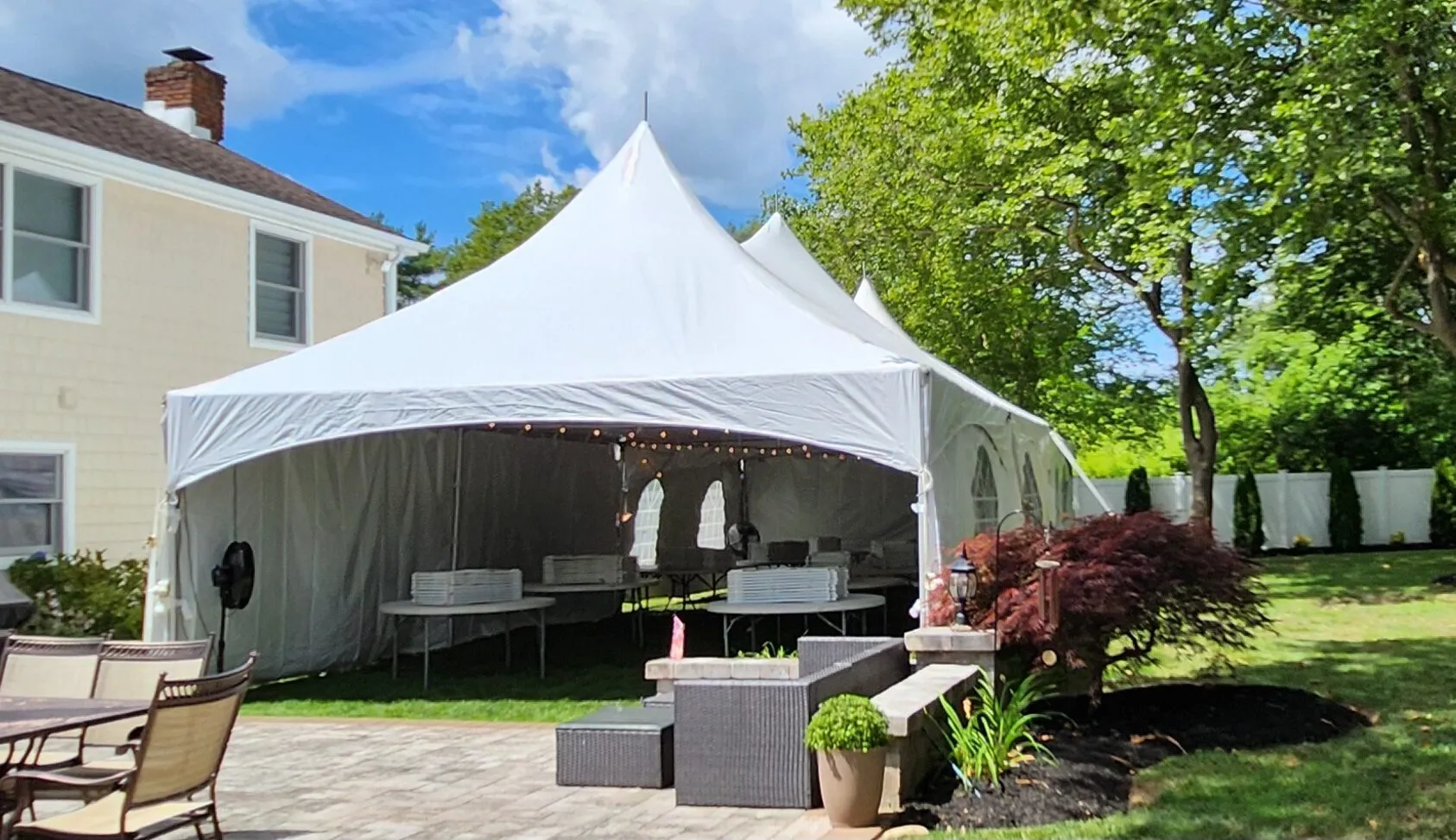 Table and chair rentals under a party tent on Long Island
